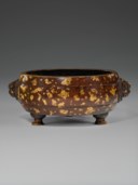 A GOLD-SPLASHED BRONZE TRIPOD CENSER