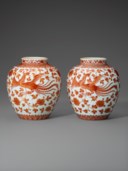A VERY RARE PAIR OF IRON-RED-DECORATED ‘DRAGON AND PHOENIX’ JARS