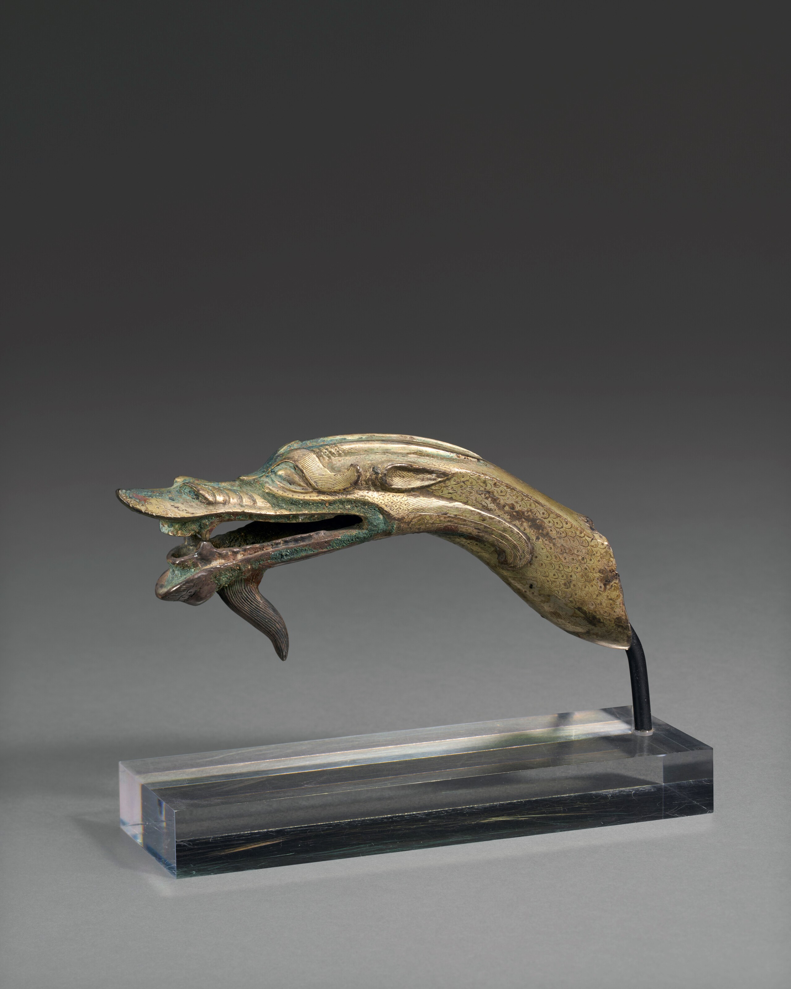 A RARE INCISED SILVER DRAGON-HEAD FITTING