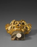 A POWERFULLY CAST GILT-BRONZE MASK-FORM SUPPORT