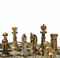 AN ENGLISH SILVER AND SILVER-GILT ELECTROPLATED AND ENAMEL-MOUNTED EBONY AND IVORY CHESS-TABLE WITH SILVER-GILT AND ENAMELLED CHESS-SET 
