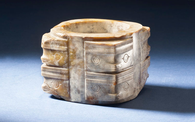 A RARE AND FINELY CARVED MOTTLED OPAQUE JADE CONG , NEOLITHIC PERIOD