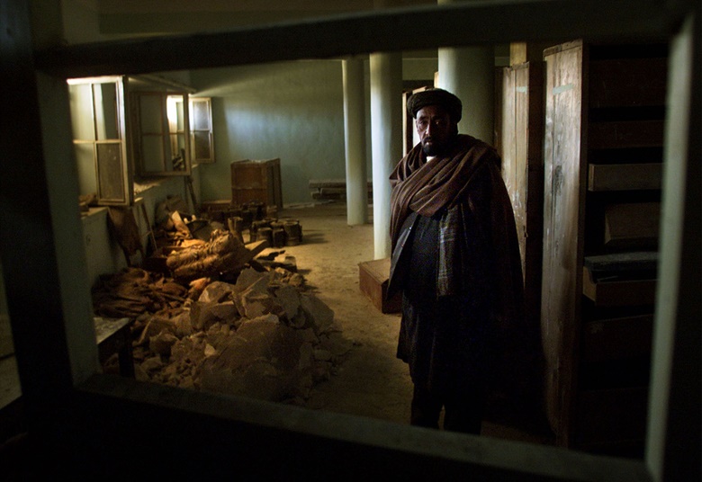 A museum official stands by the remains of ancient statues as he checks the basement of Afghanistans national museum in Kabul, December 1, 2001. Two millennia old, the statues were hacked to pieces by the Talibans religious police. Photo REUTERSDamir Sagolj