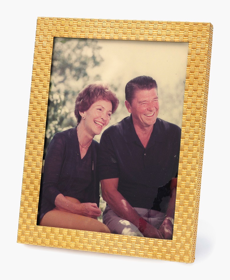 A gold picture frame. The 14k-gold frame of basketweave design, with picture of President and Mrs. Reagan. 4 ½ x 3 ½ ins. This frame was displayed in the White House while President Reagan was in office. Estimate $1,000-1,500. This lot will be offered in The Private Collection of President and Mrs. Ronald Reagan, 21-22 September at Christies in New York
