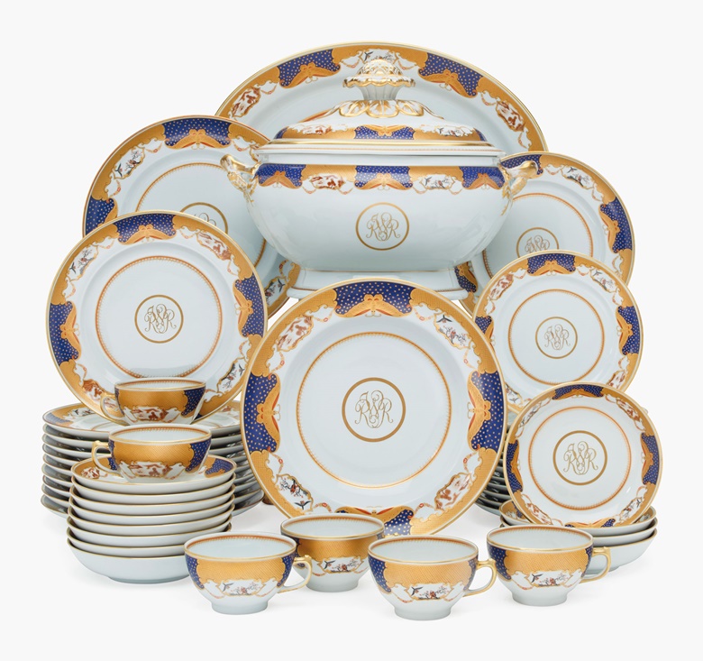 President Reagan’s Mottahedeh Porcelain Chinese Export-style monogrammed part dinner service, modern, green printed marks. The cobalt-blue border gilt with stars, trellis and butterflies among alternating landscape and bird vignettes, with gilt ‘RWR’  monogram, comprising an oval soup tureen and cover, a large oval platter, 11 dinner plates, 17 soup plates, 11 lunch plates,