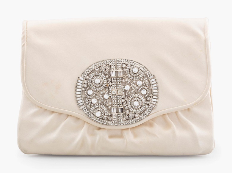 A cream satin envelope clutch bag with crystal Art Deco ornament, Judith Leiber, 1984. Estimate $300-500. This lot will be offered in The Private Collection of President and Mrs. Ronald Reagan, 21-22 September at Christies in New York