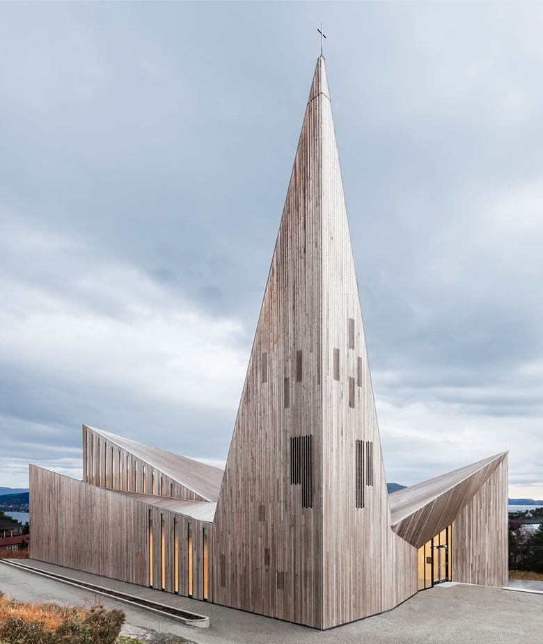 Community Church, Knarvik, Norway. Reiulf Ramstad Arkitekter, 2014 This dramatic building on the Norwegian coast is a modernist take on the wooden stave churches of Scandinavia. The ‘windows’ on the jag of a spire are in the  same wood as the rest — but heartwood, which is darker. These rectangular patches make the pale sapwood steeple seem less sharp and dangerous, less