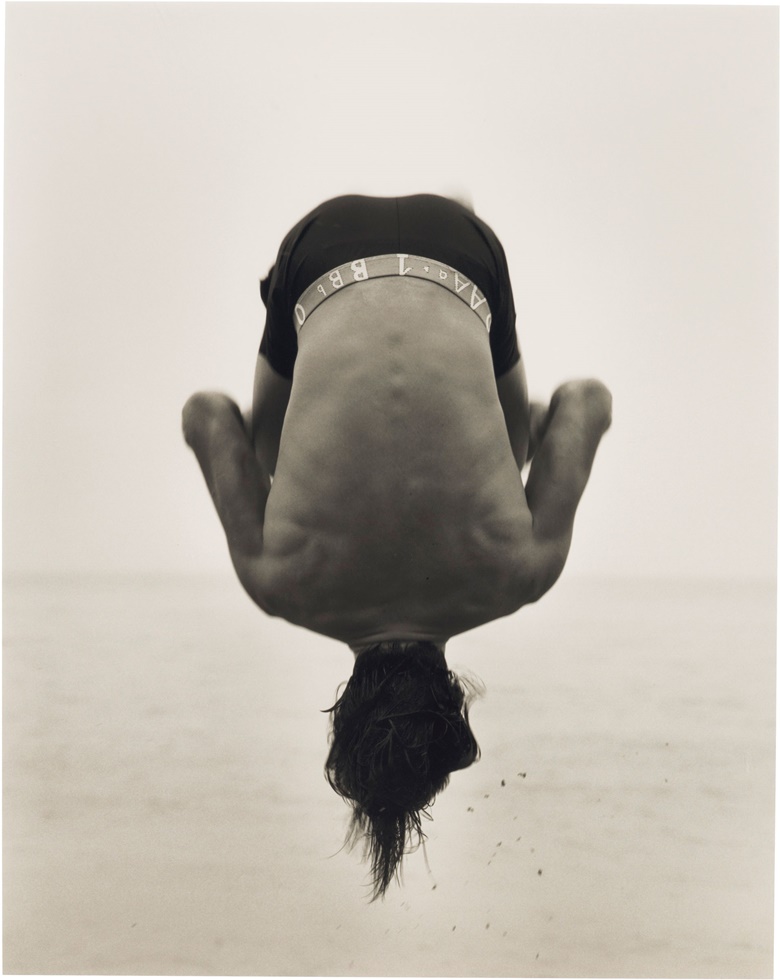 Herb Ritts (1952–2002), Backflip, Paradise Cove, 1987. Gelatin silver print signed, titled, dated and numbered ‘125’ in pencil (mount, verso). Image 19 x 15¼ in (48.3 x 38.7 cm), sheet 20 x 16 in (50.8 x 40.7 cm), mount 21½ x 17½ in (54.6 x 44.5 cm). This print is number 1 from the edition of 25 plus 3 artist’s proofs. This lot is offered in Photographs