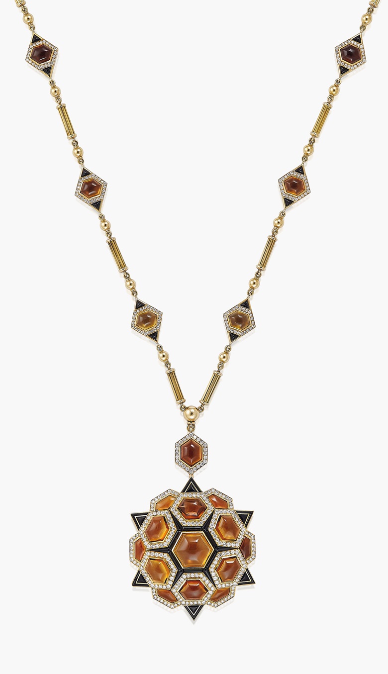 A quartz, onyx and diamond pendantbrooch necklace, by Bulgari. The pendant of stylised star design, set with cabochon smokey quartz, onyx panels and diamond accents, to the longchain necklace of reeded bar-link design, interspersed with smokey quartz, onyx and diamond panels, circa 1975. Pendant 8.0 cm, necklace 73.0 cm, mounted in gold, in pink leather Bulgari brooch. Estimate