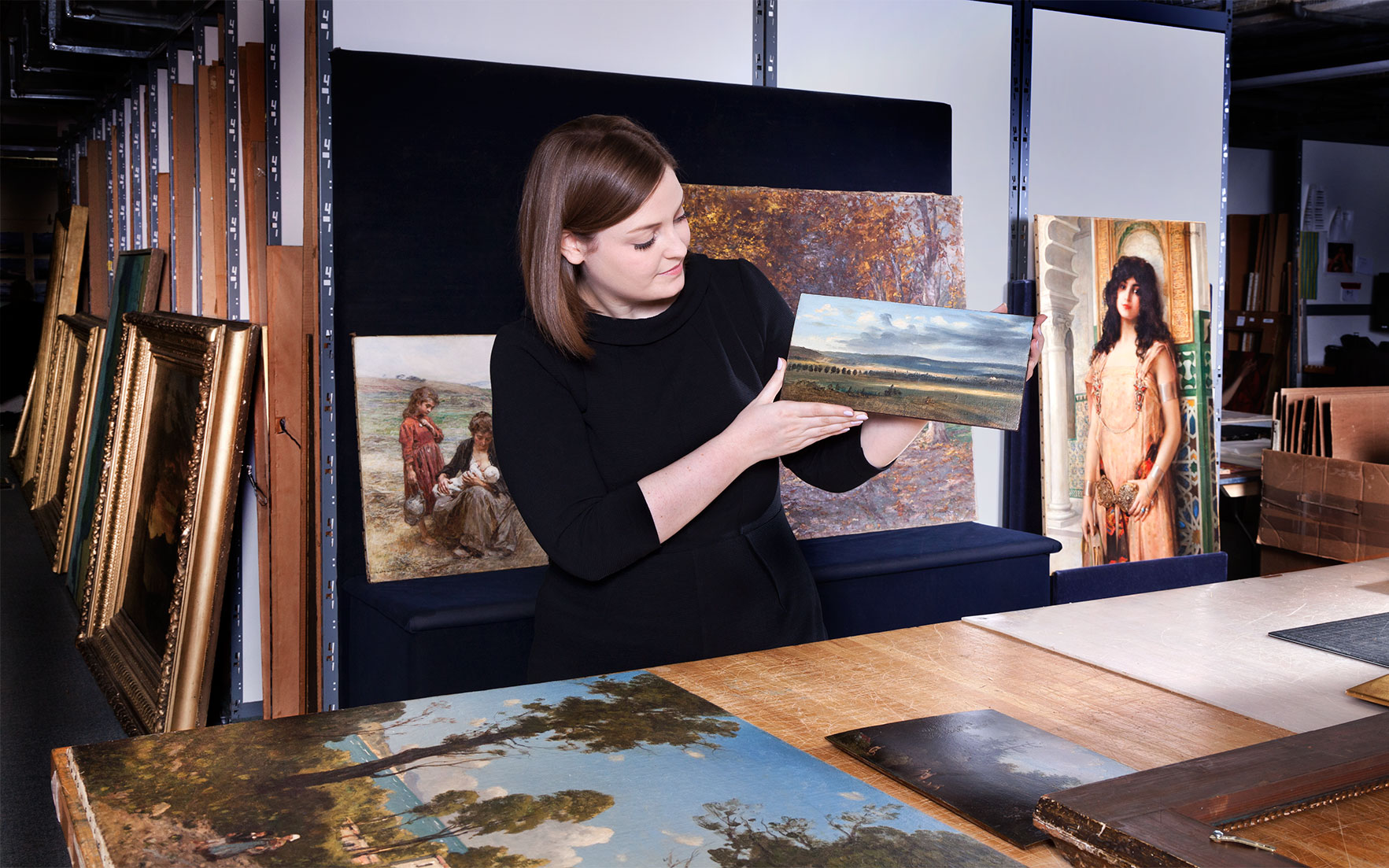 Laura Mathis with a Theodore Rousseau landscape Christie's