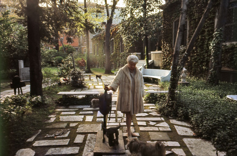 Peggy Guggenheim and her dogs in the palazzo gardens, with Germaine Richier’s sculpture, Tauromachy, 1953. Photo Ray Wilson. Courtesy of Peggy Guggenheim Collection Archives. Artwork © Germaine Richier, DACS 2021