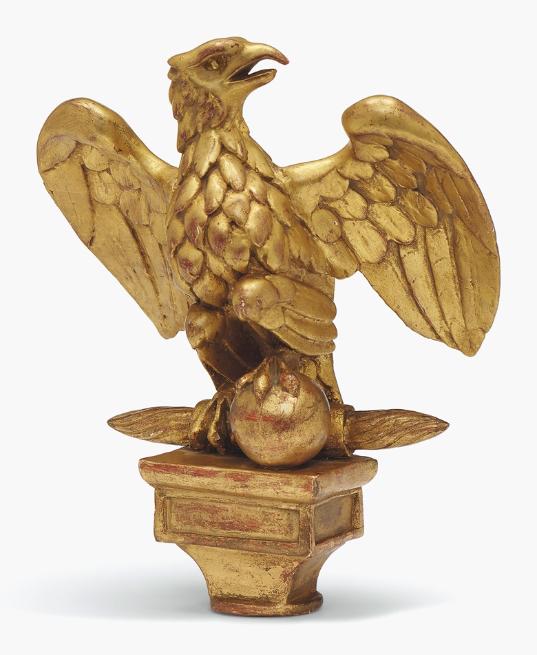 A French giltwood pennant finial of a Napoleonic eagle, early 19th century. 9¾ in (25 cm) high. Estimate £400-600. This lot is offered in Interiors on 14 June 2017 at Christie’s South Kensington