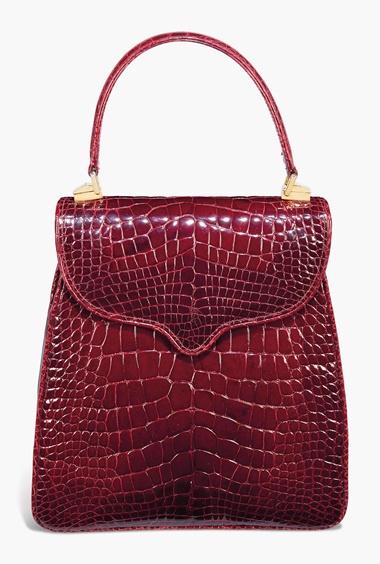 A burgundy alligator Princess Diana handbag. By Lana Marks, 1995. 9 x 9½ in (22 x 24 cm). Estimate £4,000-6,000. This lot is offered in The Collection of Raine, Countess Spencer on 13 July 2017 at Christie’s in London, King Street