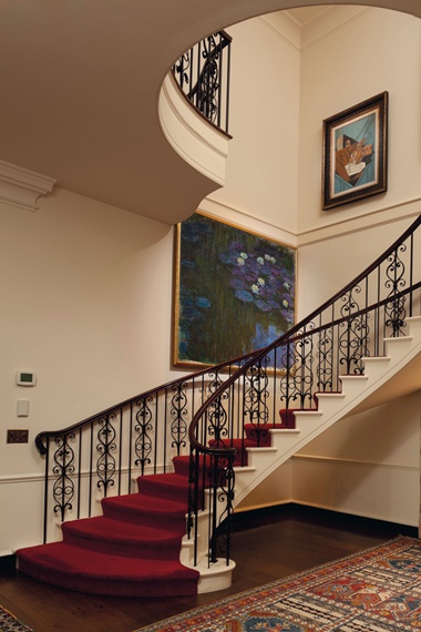 Claude Monet’s Water Lilies (Nymphéas) hanging in the stairwell at Hudson Pines, with La table du musicien by Juan Gris above it