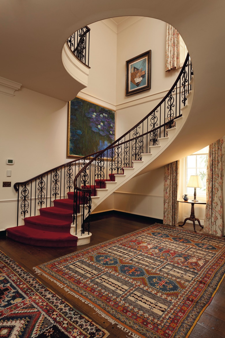 The stunning Monet in the stairwell of the Hudson Pines home of Peggy and David Rockefeller