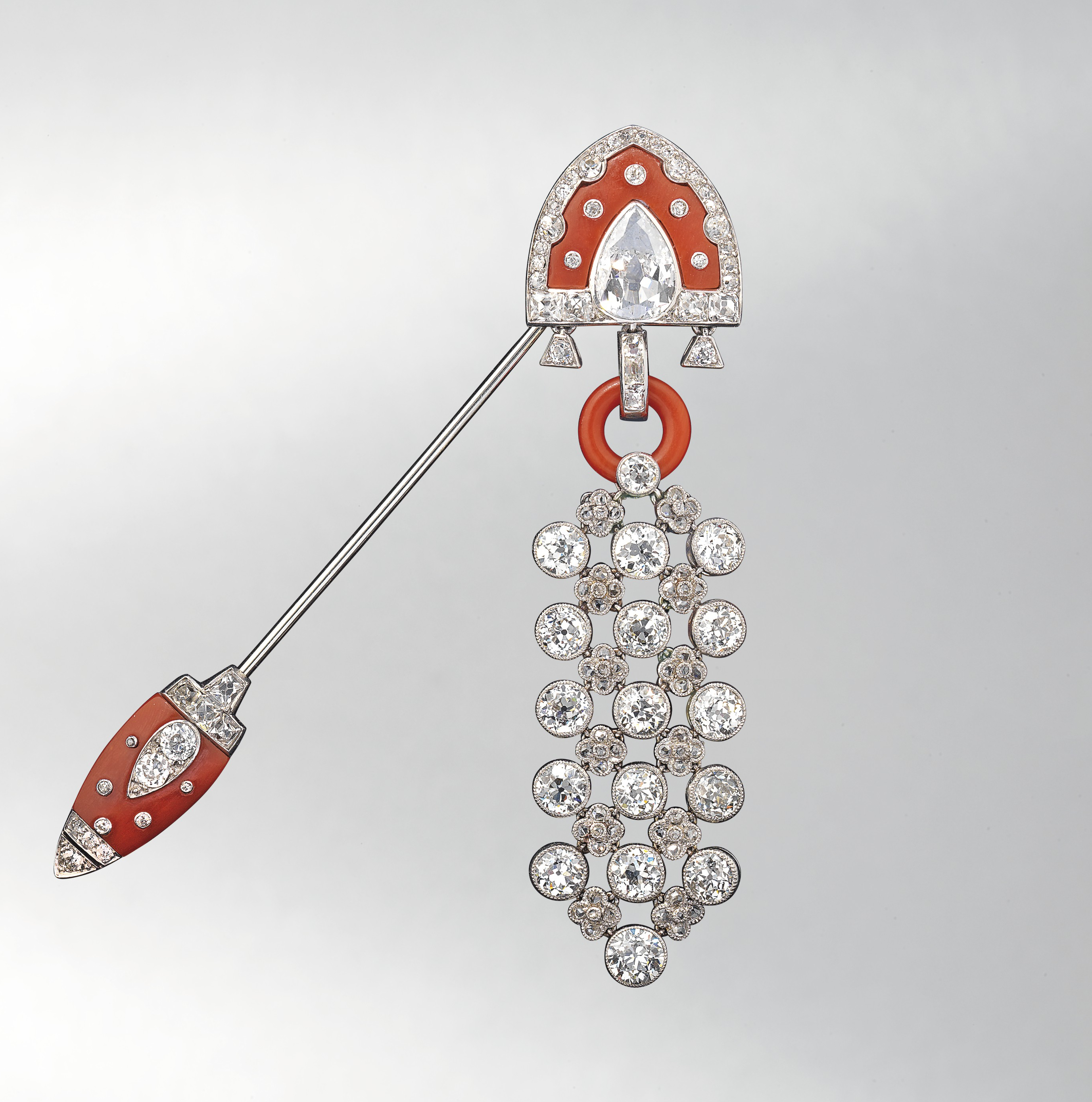 A fine and rare Art Deco coral and diamond jabot pin. Cartier, c. 1920. Signed ‘Cartier’ and numbered. Height 7.5 cm. Estimate £25,000-35,000. Offered in Important Jewels at Christie’s in London on 13 June 2018