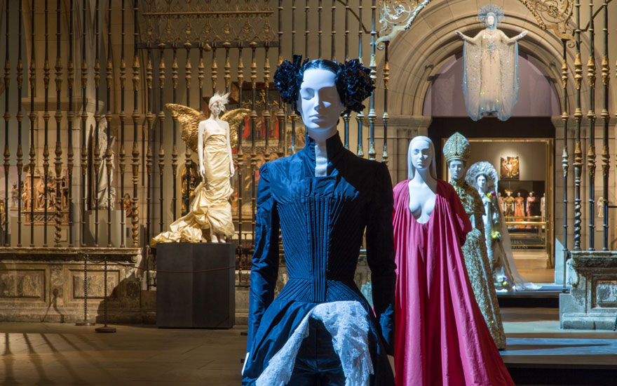 Gallery view in the Medieval Sculpture Hall. From the front Alexander McQueen for House of Givenchy, evening ensemble, springsummer 1999; Pierpaolo Piccioli for Valentino, evening dress, autumnwinter