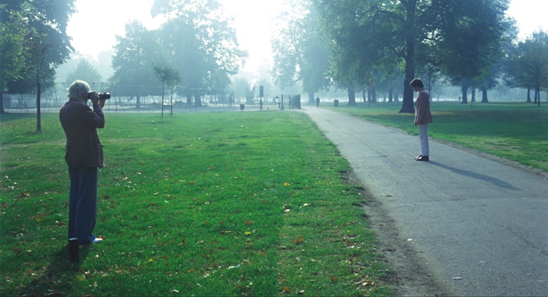 In London Hockney took photographs of his partner, Peter Schlesinger, in Kensington Gardens, from which he also worked to create the pink-jacketed figure standing at the pool’s edge. Film still from A Bigger Splash, 1974. Photo Jack Hazan  Buzzy Enterprises Ltd