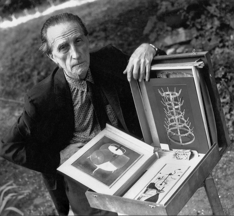 Marcel Duchamp with a Boîte-en-valise, photographed circa 1957. Photo © Michel Sima  Bridgeman Images. Artwork © Association Marcel Duchamp  ADAGP, Paris and DACS, London
