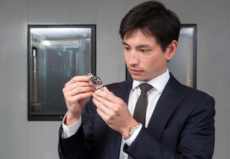 Ryan Chong inspects a Rolex GMT-Master with a ‘Coke’ colour-blocked bezel