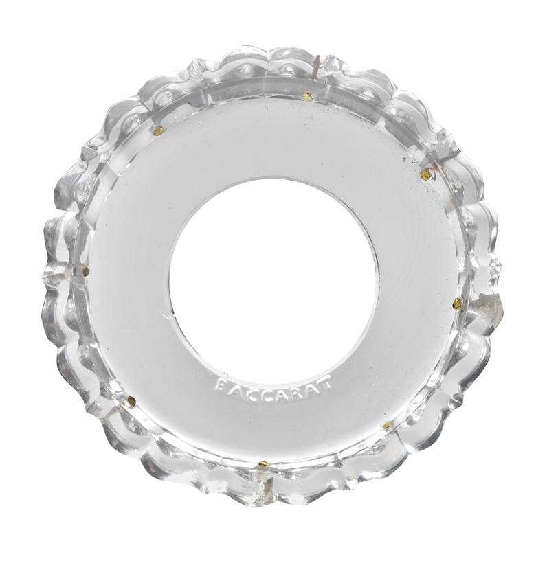 Baccarat’s mark is visible on this glass drip pan — or bobèche — from the chandelier