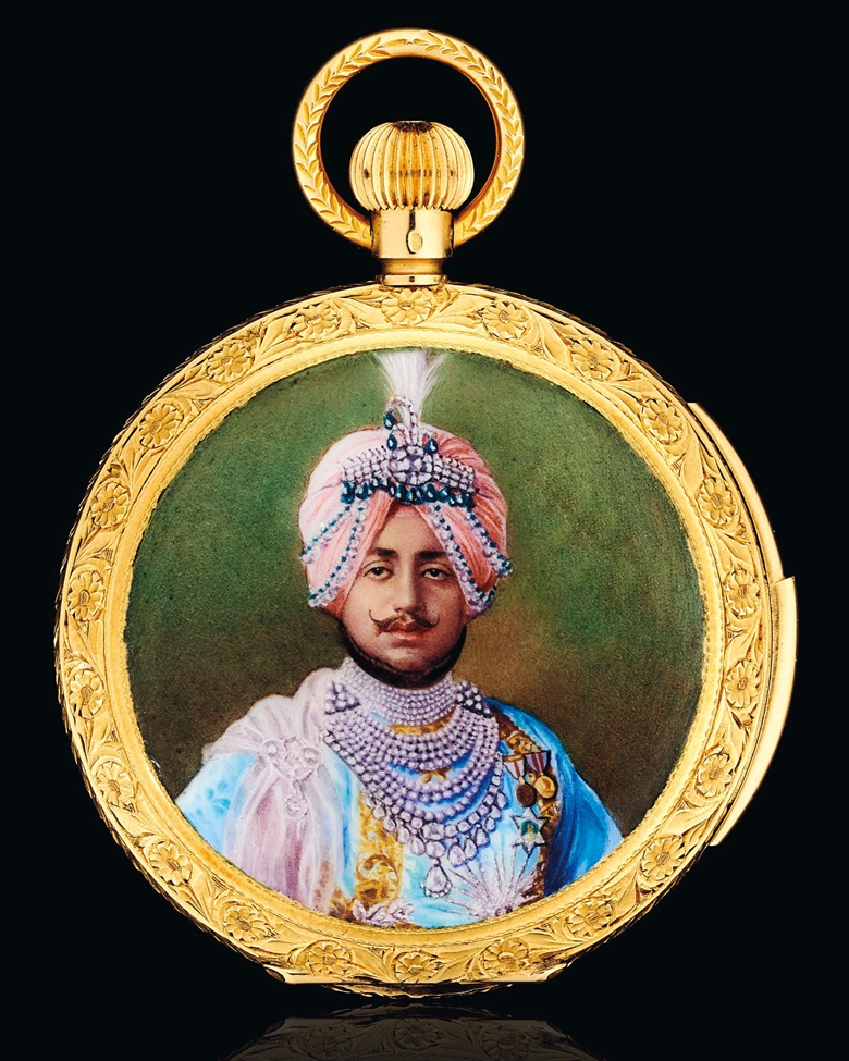 An enamel and gold hunting case pocket watch. Champlevé enamel portrait depicting Maharaja Bhupinder Singh of Patiala, enamel coat of arms on the reverse, white enamel dial, 18k gold (British and Swiss hallmarks), 2½ in, case no. 34894, circa 1930