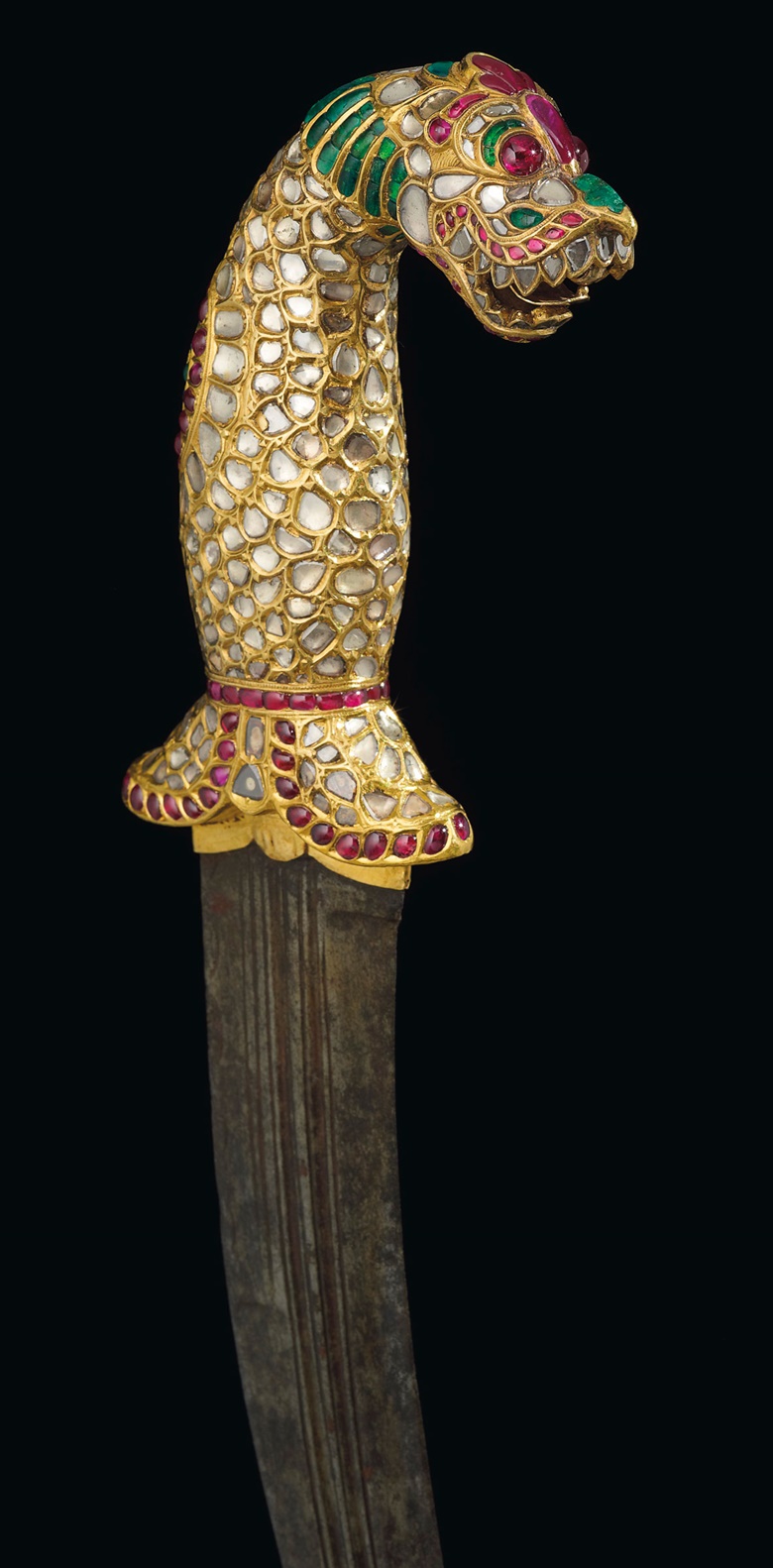 A gold gem-set hilted dagger (Kinjal). The hilt in the form of a yali, set with diamonds, rubies and emeralds, steel blade. Tanjore or Mysore, South India, 1790-1810