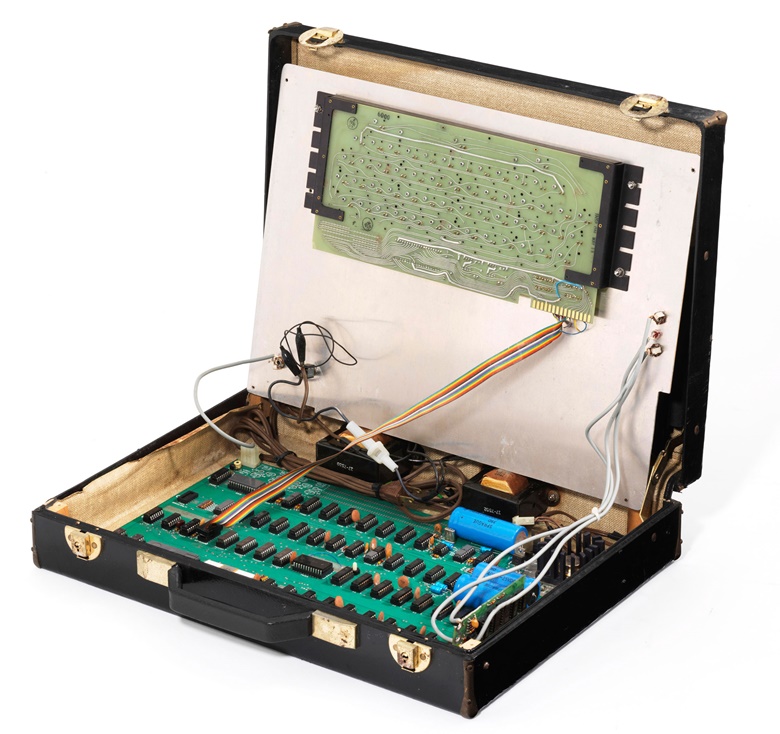 This Apple-1 personal computer is housed in a briefcase. The keyboard lifted to show the mainboard fixed into place
