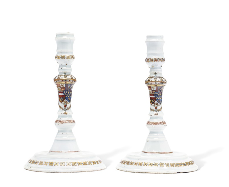 A pair of Chinese export candlesticks with the arms of Philip V of Spain, circa 1725-30.  8½ in (21.6 cm) high.