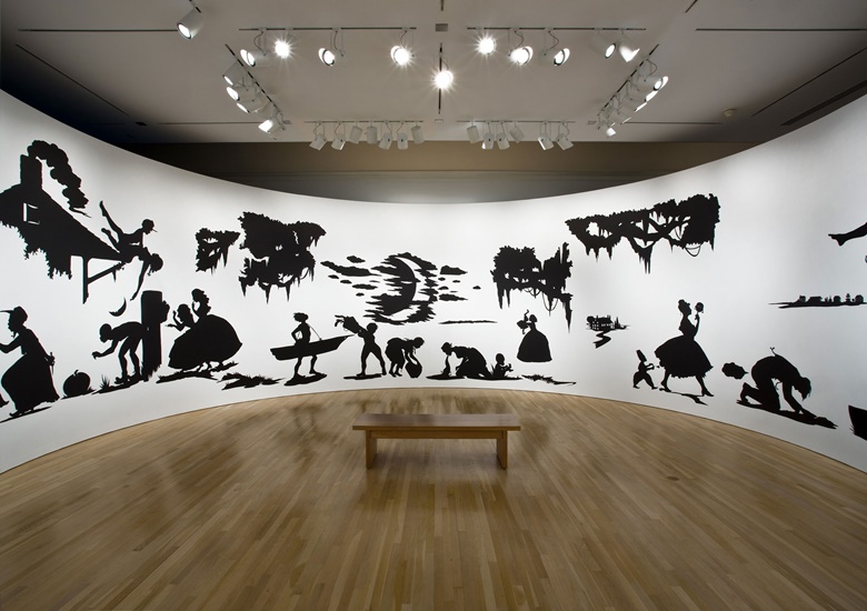 Kara Walker, Slavery! Slavery! Presenting a GRAND and LIFELIKE Panoramic Journey into Picturesque Southern Slavery or Life at Ol Virginnys Hole (sketches from Plantation Life). See the Peculiar Institution as never before! All cut from black paper by the able hand of Kara Elizabeth Walker, an Emancipated Negress and leader in her Cause, 1997. Cut paper on wall. Installation dimensions variable;