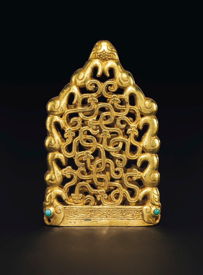 A superb and extremely rare turquoise-inlaid gold openwork chape, Northwest China, 6th-5th century BC. 2⅛  in (5.3  cm) high. Estimate $300,000-500,000. Offered in Masterpieces of Early Chinese Gold and Silver on 12 September 2019 at Christie’s in New York