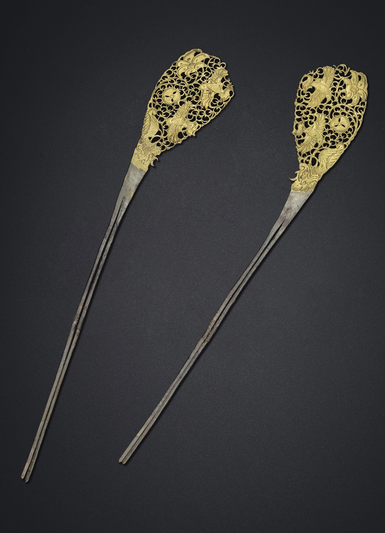 A rare pair of parcel-gilt silver hairpins, Tang dynasty (AD 618-907). Each 11  in (28  cm) long. Estimate $40,000-60,000. Offered in Masterpieces of Early Chinese Gold and Silver on 12 September 2019 at Christie’s in New York