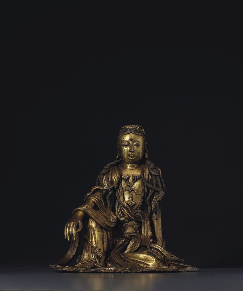 A very rare gilt-bronze figure of white-robed Guanyin, China, Ming dynasty, 15th century. 10⅛ in (25.6 cm) high. Estimate $400,000-600,000. Offered in Sacred and Imperial The James and Marilynn Alsdorf Collection Part I  on 24 September 2020 at Christie’s in New York