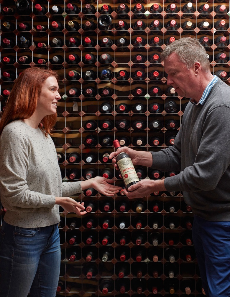 Christopher Munro, Head of Wine & Spirits at Christie’s in New York, admires a bottle of Pétrus from the collection