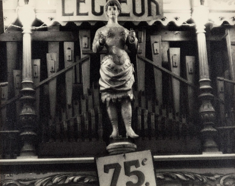 Ilse Bing, Orgue de Barbarie, Foire aux Pains d’Epices, 1933. Gelatin silver print, hinged to paper album page. Sheet 8⅞ x 11⅛ in (22.5 x 28.2 cm). Estimate $3,000-5,000. Offered in From Pictorialism into Modernism 80 Years of Photography, 30 April-13 May, Online