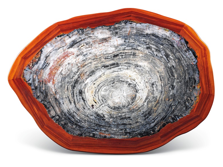 A large petrified wood table. 40 cm x 146 cm x 105.5 cm. Estimate £10,000-15,000. Offered in Sculpted by Nature Fossils, Minerals and Meteorites, 4-21 May 2020, Online