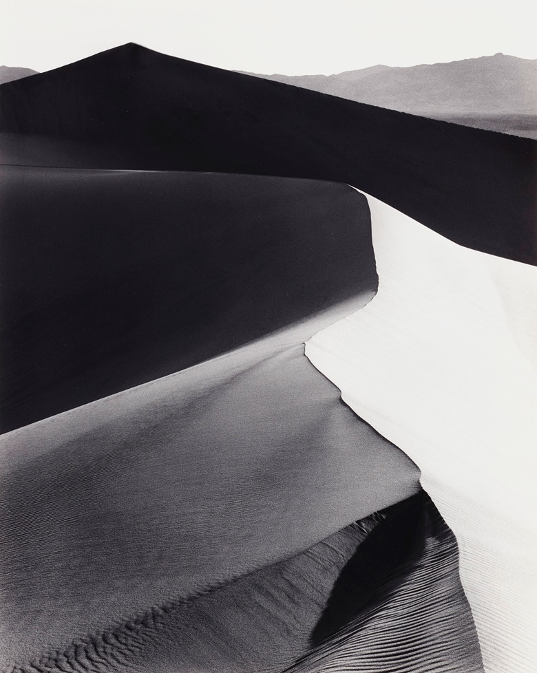 Ansel Adams (1902-1984), Sand Dunes, Sunrise, Death Valley National Monument, California, c. 1948. Gelatin silver print, mounted on board, printed 1973-1977. Imagesheet 18¼ x 14¾ in (46.3 x 37.4 cm); mount 27½ x 21¾ in (69.8 x 55.2 cm). Estimate $15,000-25,000. Offered in Ansel Adams and the American West, 25 March-8 April, Online