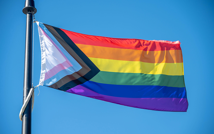 A pride flag on a flag pole