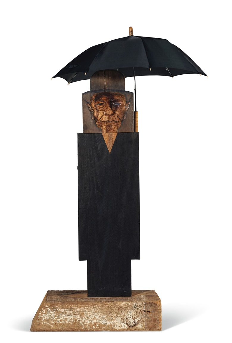 Marisol Escobar (1930-2016), Magritte II, 1998. Oil, charcoal, plaster, cloth, wood and umbrella. 67½ x 41½ x 32½ in (171.5 x 105.4 x 82.6 cm). Estimate $120,000-180,000. Offered in Post-War and Contemporary Art Day Sale on 12 November 2021 at Christie’s in New York