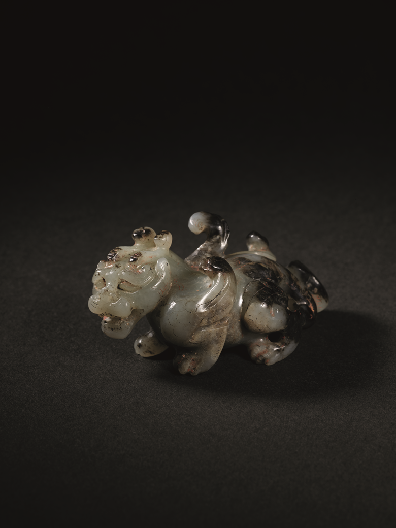 An exceedingly rare and exceptional jade carving of a mythical beast, bixie. Late Western Han Dynasty, c. 1st Century BC. 7.2 cm (2⅞ in) long, box. Sold for HK$26,850,000 in The Chang Wei-Hwa Collection of Archaic Jades Part IV The Qin and Han Periods on 29 November 2022 at Christie’s in Hong Kong
