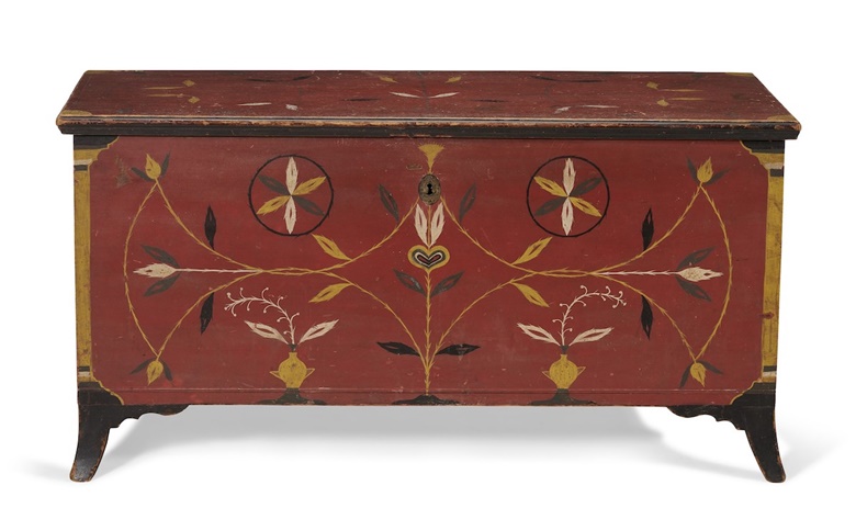 A federal red-painted and polychrome-decorated poplar blanket chest, Pennsylvania, 1815-1825. In shades of yellow, green, white and black on a red ground. 25½  in high, 49¾  in wide, 20¾  in deep (65 x 126.5 x 53cm). Estimate $70,000-90,000. Offered in The Collection of Peter and Barbara Goodman on 20 January 2022 at Christie’s in New York