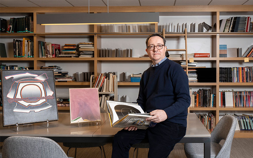 Stephen Jones in the Christies Rockefeller Center library with Deborah Remington (1930-2010), Gallatin, 1976. Oil on linen. 20 x 18 in (50.8 x 45.7 cm). Estimate $10,000-15,000, and Helen