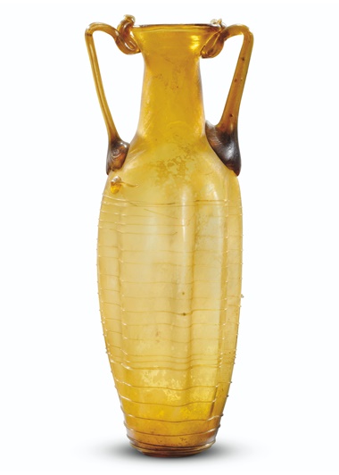 A Roman amber glass amphoriskos, circa 3rd century AD. 8⅞ in (22.6 cm) high. Sold for £10,625 on 8 December 2021 at Christie’s in London