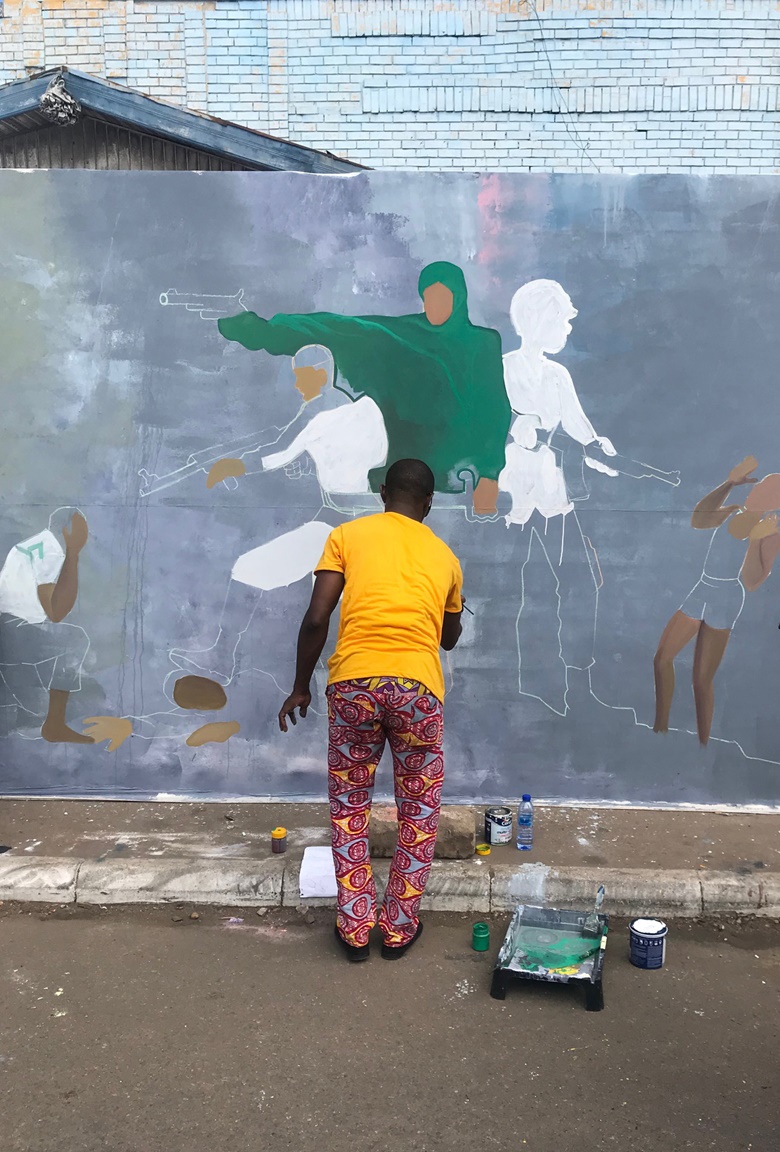 An artist working on the Accra Royal Mural Wall during the Chale Wote Street Art Festival. Photo Holly Black