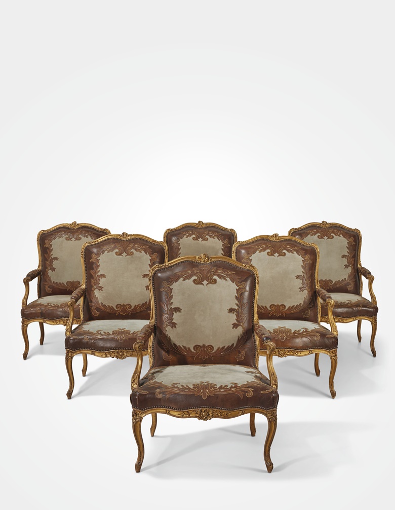 Claude Sené I (b. 1724), A set of six Louis XV armchairs, mid-18th century. Gilt beechwood, each stamped C.SENE on the rear seat-rail, upholstered in embroidered grey suede and two-tone brown leather. 40 1⁄4 high x 30 1⁄4 in wide (102, x 77 cm). Estimate €100,000-200,000. Offered in Hubert de Givenchy - Collectionneur Chefs-doeuvre, 14 June at Christies Paris