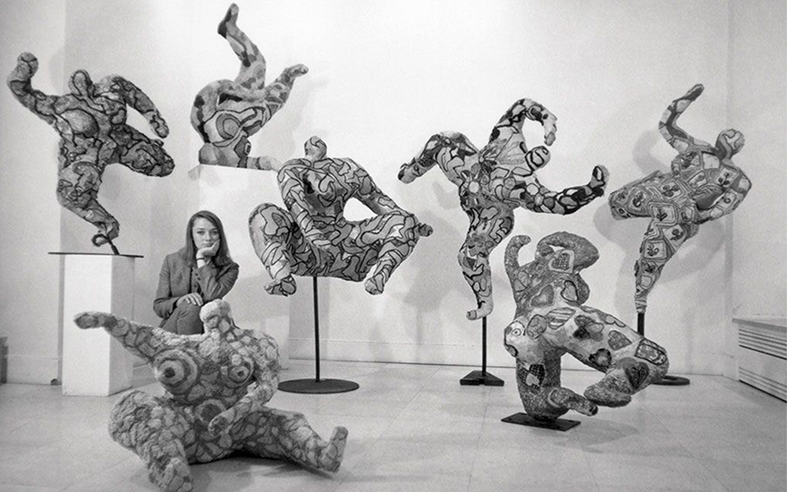 Niki de Saint Phalle posing with her Nanas at Galerie Alexandre Iolas, Paris, 1965. © André Morain