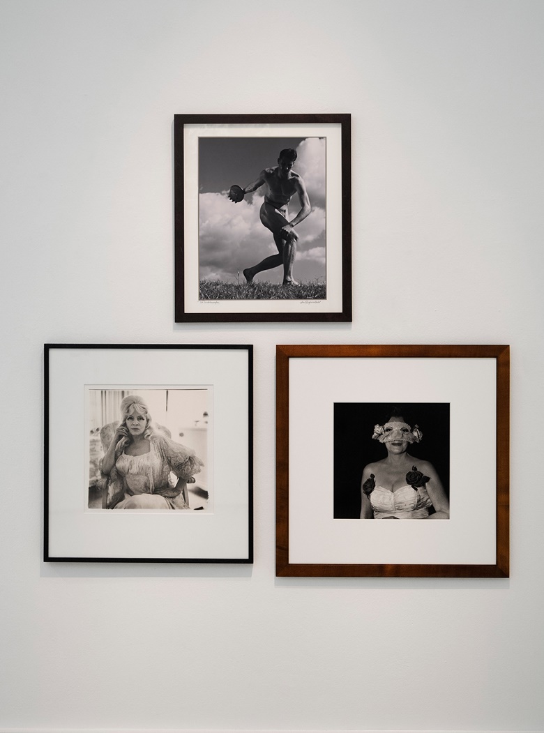 Installation view of works by Leni Riefenstahl and Diane Arbus. Clockwise, from top Leni Riefenstahl (1902-2003), Der Diskuswerfer, 1936; Diane Arbus (1923-1971), Lady at a Masked Ball with Two Roses on Her Dress N.Y.C., 1967; Diane Arbus, Mae West in a Chair at Home, Santa Monica, 1965. Photo © CAMERA WORK Gallery