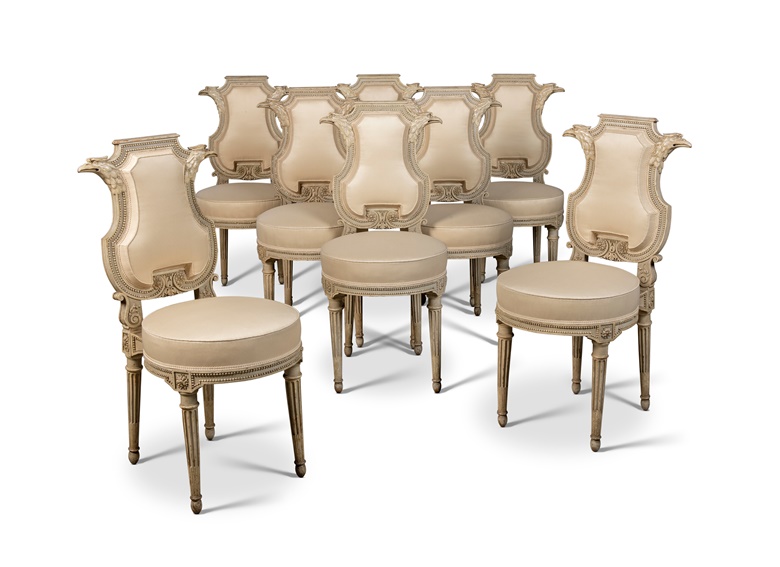 A set of eight Louis XVI grey and white-painted chaises with lyre-shaped chanelled backs flanked by eagle heads, by Georges Jacob, circa 1785, formerly in the collection of the mining magnate Sir Alfred Chester Beatty (1875-1968). 36 in (91 cm) high; 17 in (43 cm) wide; 20 in (51 cm) deep. Estimate £120,000-180,000. Offered in Provenance Revealed Galerie Steinitz on 21 September 2022 at