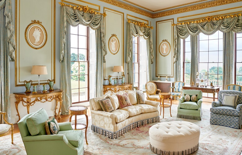 The drawing room at Bowden Park. Against the wall on the left is a pair of George III gilt-brass mounted marquetry and giltwood pier tables, circa 1770; and by the windows on the right, a pair of George III giltwood armchairs, circa 1775, attributed to Thomas Chippendale Jr. Offered in The Collection of Lord & Lady Weinstock on 22 November 2022 at Christie’s in London