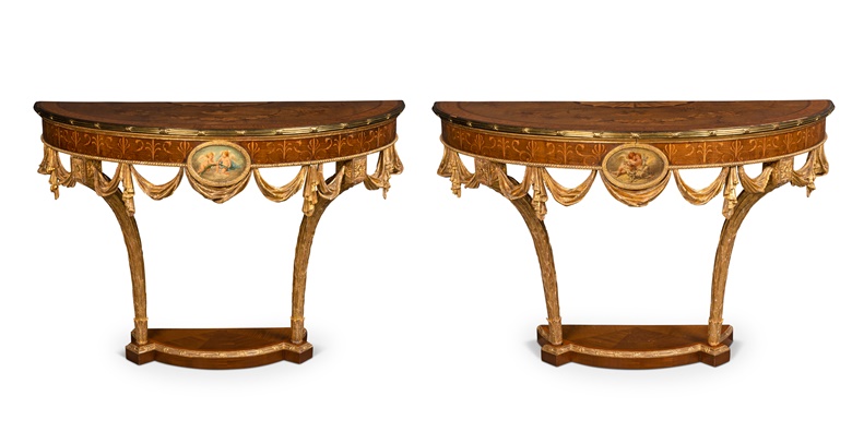 A pair of George III gilt-brass mounted marquetry, painted and giltwood demi-lune console tables, circa 1770. Attributed to William Ince and John Mayhew. 33½ in (85 cm) high; 51¾ in (131.5 cm) and 47¾ in (121.3 cm) wide; 23¾ in (60.5 cm) deep.